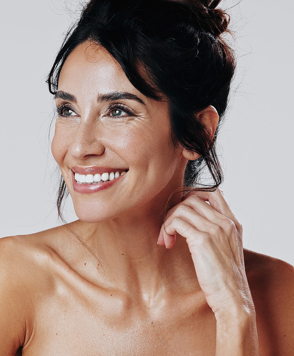 Smiling woman with natural beauty and glowing skin.