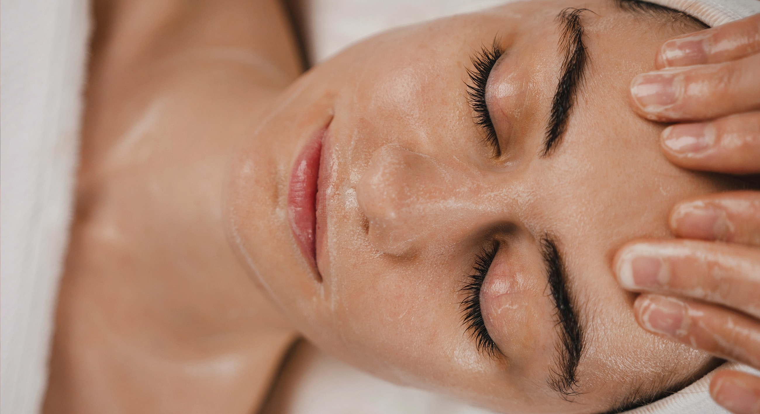 Woman receiving a facial treatment in spa.